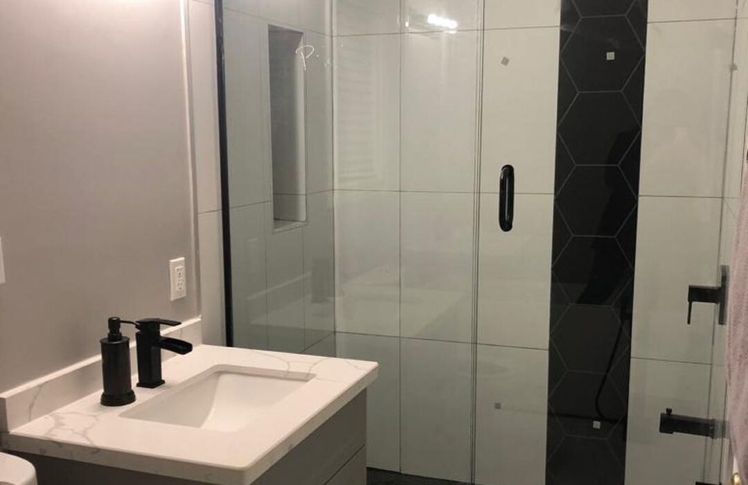 Bathroom renovation with a glass shower screen and a white vanity