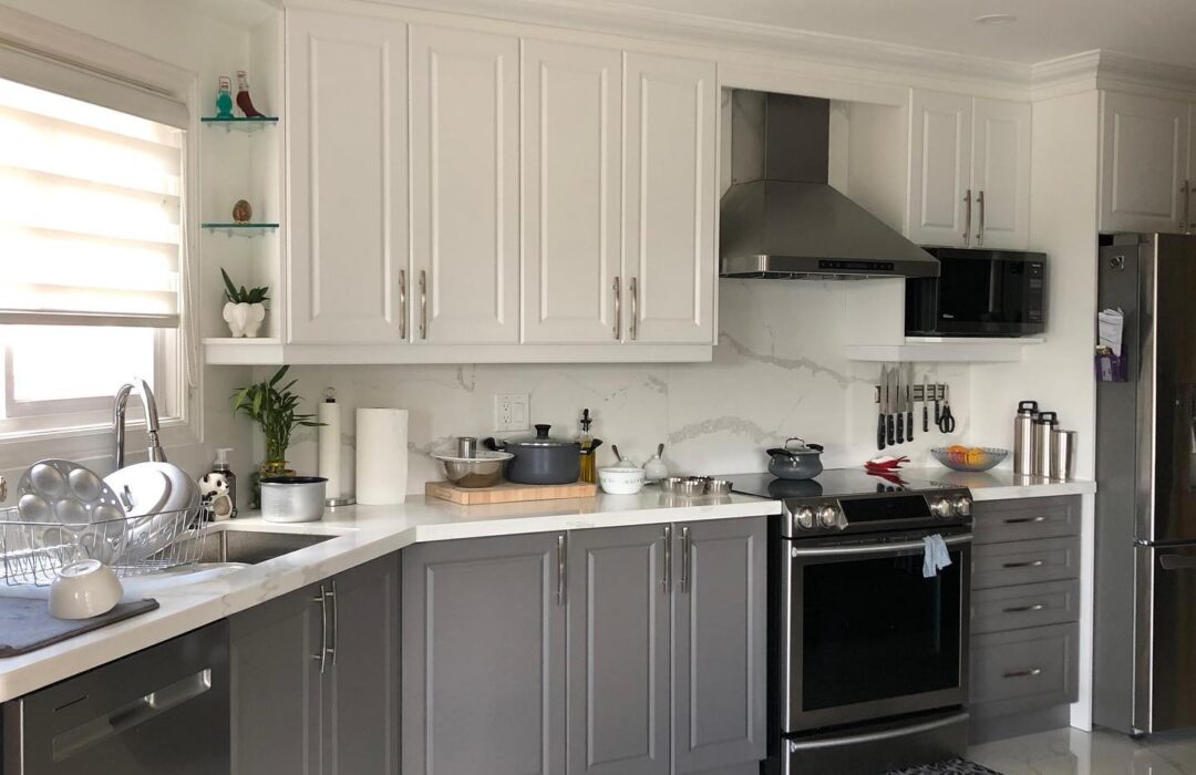 Renovated kitchen with white cabinetry and dark lower cabinets