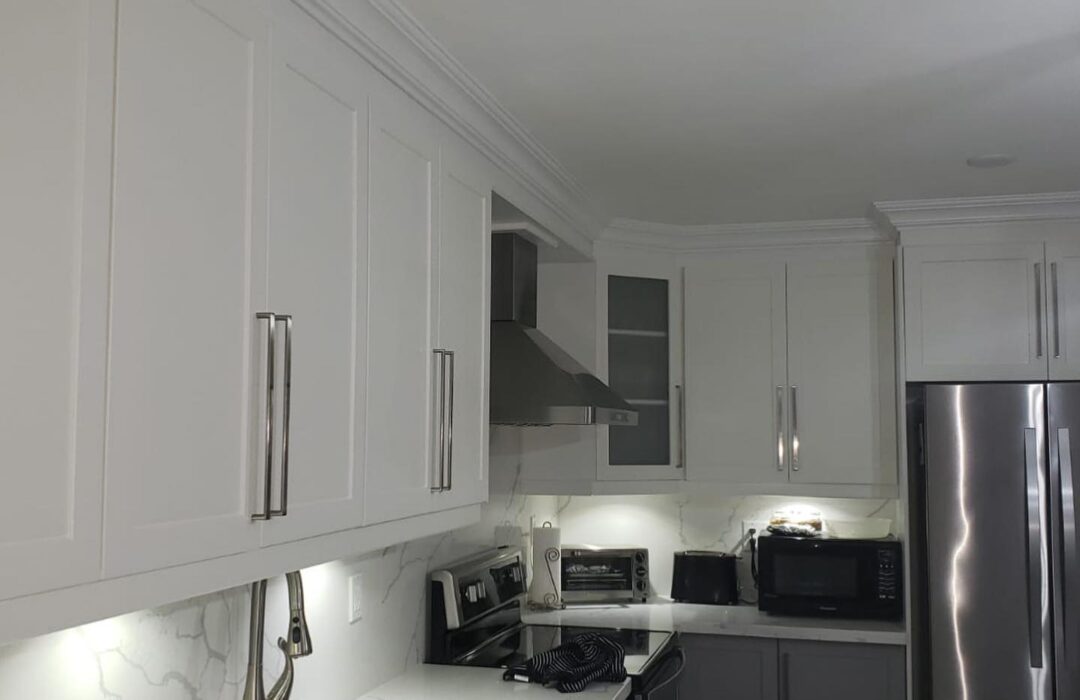 Kitchen cabinetry, range and counter after renovation