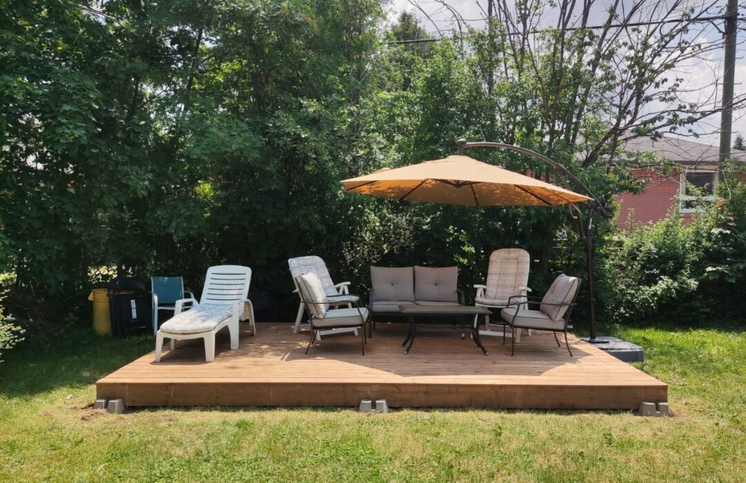 Backyard timber deck with outdoor seating and an umbrella