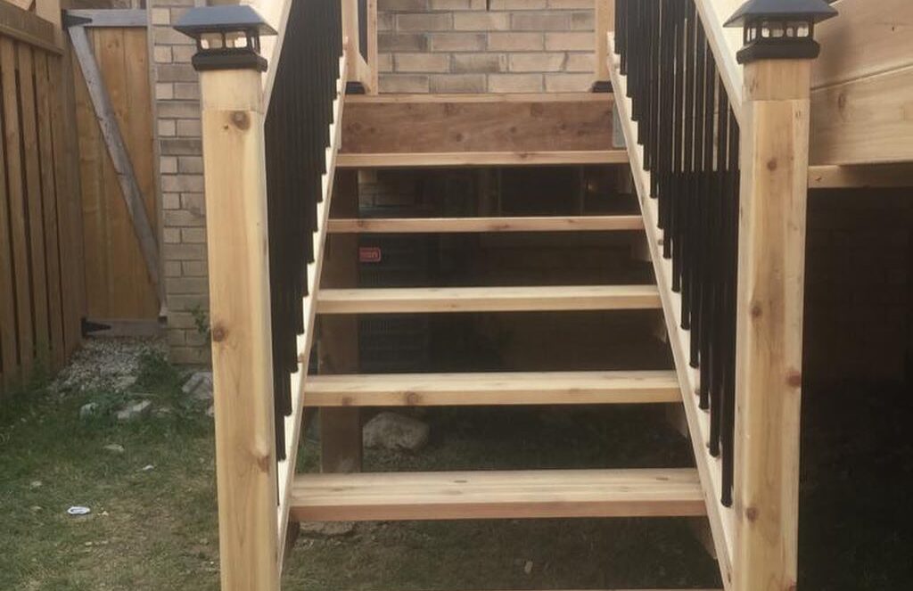 Outdoor timber steps between matching deck posts
